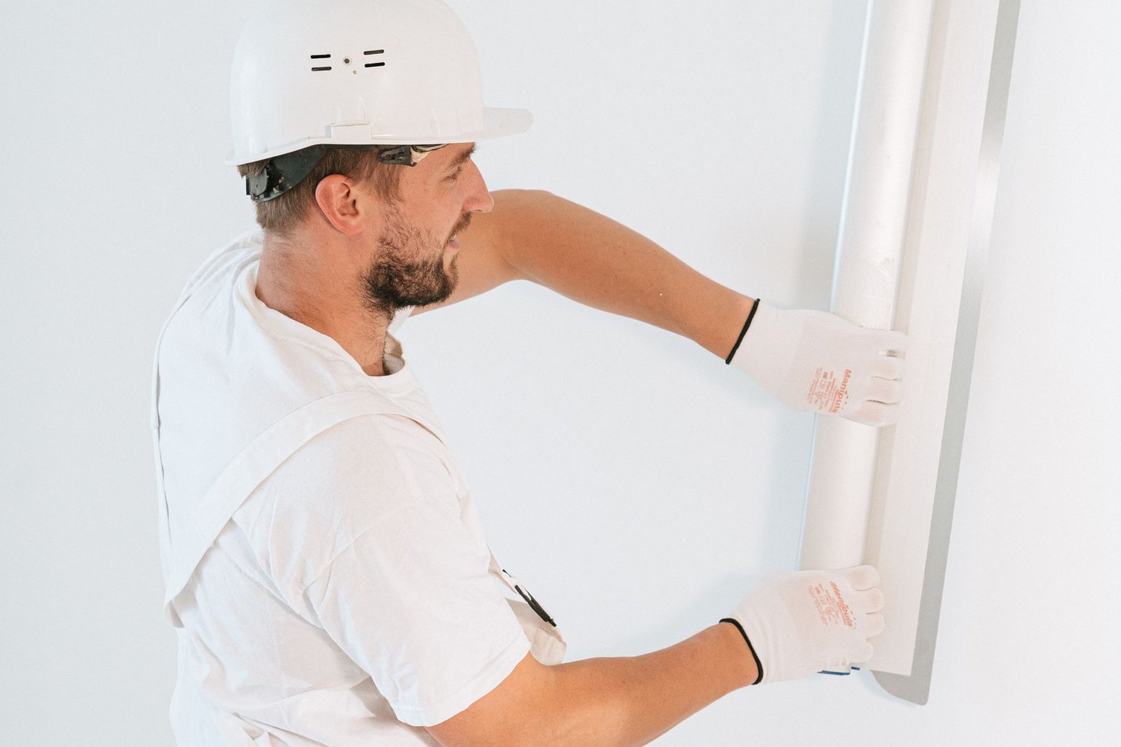 Construction professional installing and aligning an interior drywall system