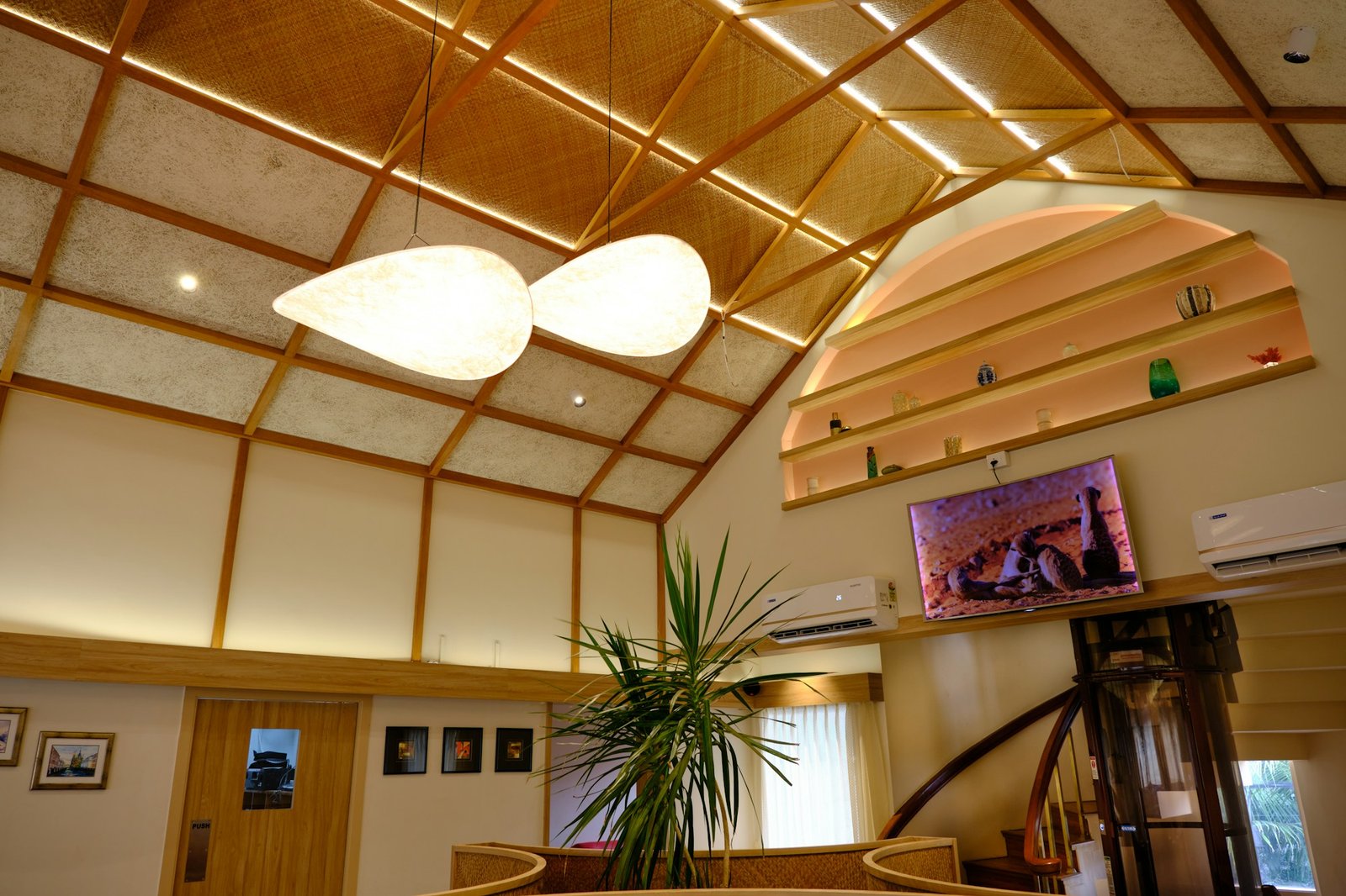 Warm contemporary interior showcasing a detailed ceiling and integrated lighting