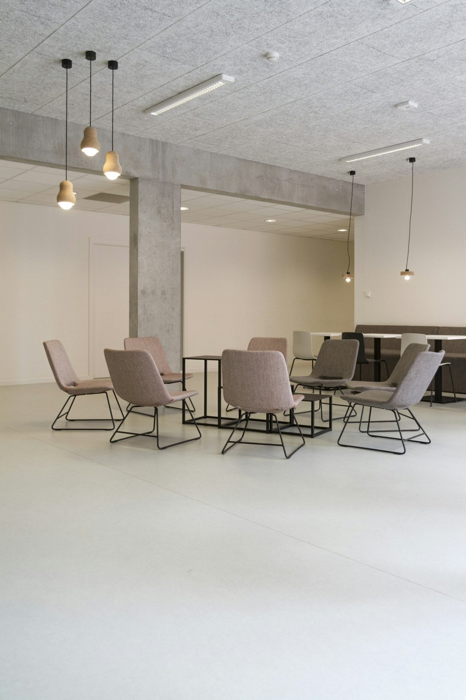 Bright contemporary lounge with acoustic ceiling panels and pendant lighting